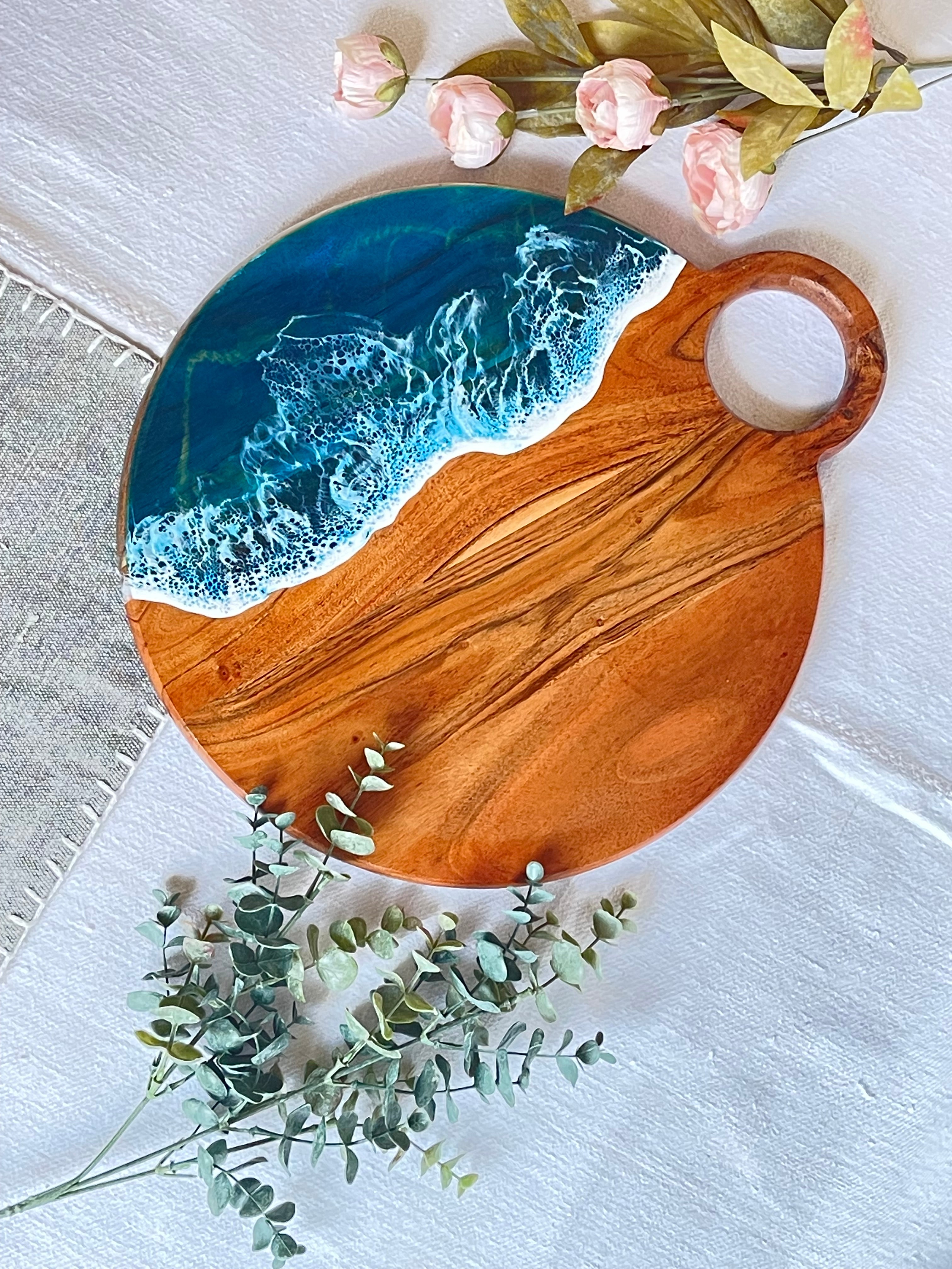 Resin art ocean waves on round charcuterie board top with handle