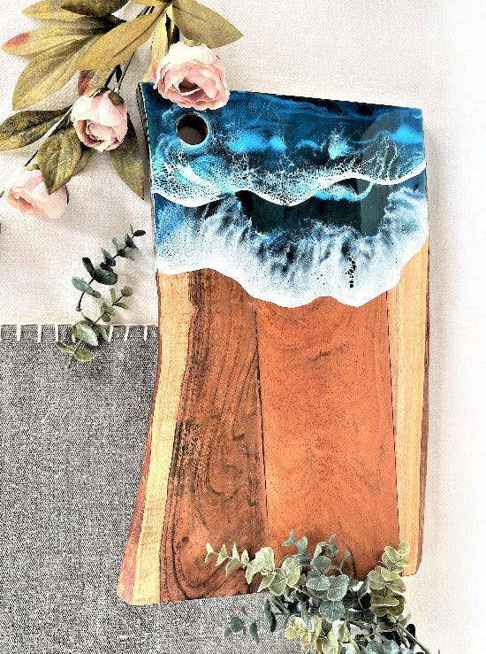 Live edge acacia charcuterie board wood slab with resin art ocean waves.